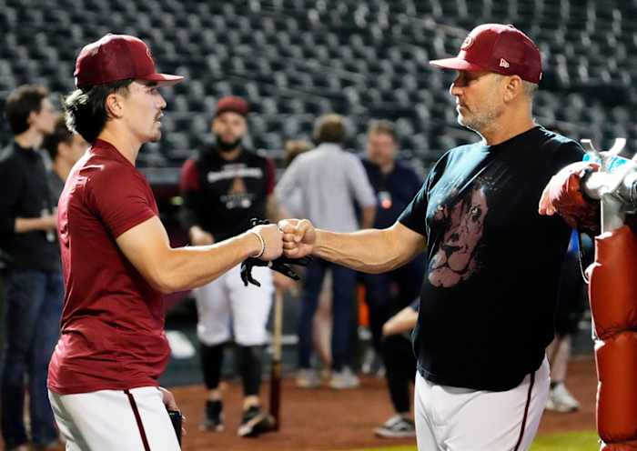 Torey Lovullo fist bumps Corbin Carroll during batting practice.